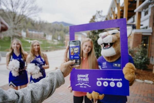 a person taking a selfie with a mascot